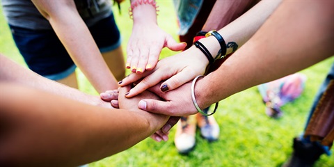 Empower Youth - Young people making unity gesture